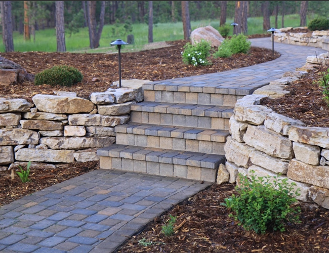 A beautiful new patio made from small rocks and large flagstones.