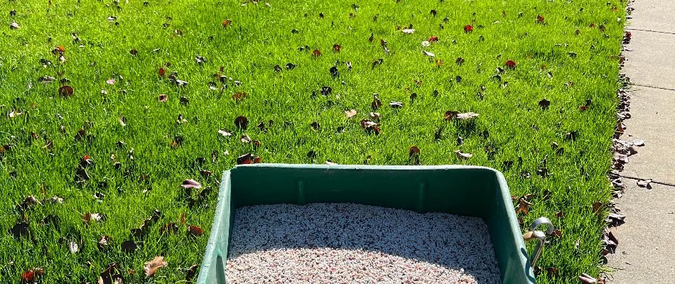 Green lawn in Matthews, NC, with fertilizer and equipment.