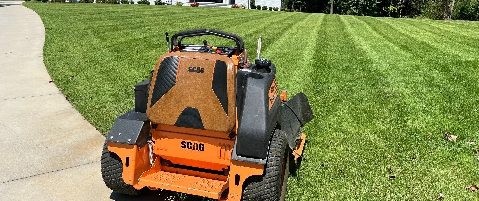 A recently mowed lawn in Matthews, NC, with an orange mower.