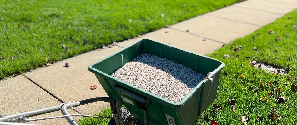 Granular fertilizer on a spreader equipment on top of a lawn in Millingport, NC.