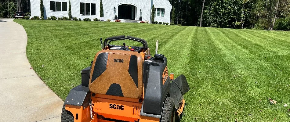 Lawn mower near a lawn in Albemarle, NC, with mowing pattern.