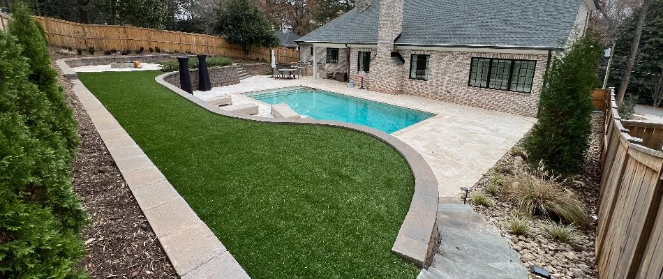 Pool with a deck and artificial turf in Oakboro, NC.